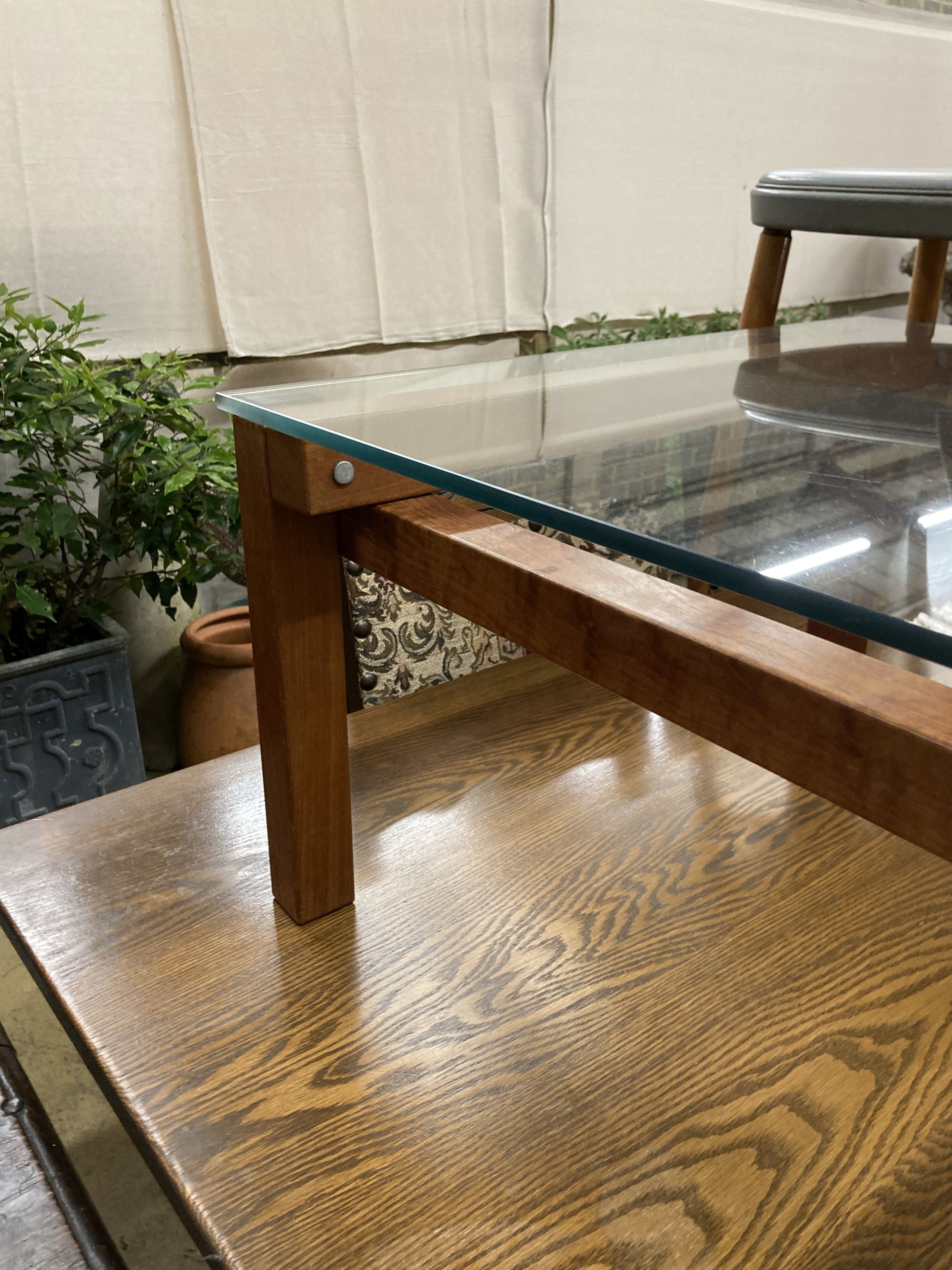 A John Makepeace square glass top coffee table, width 64cm, height 35cm